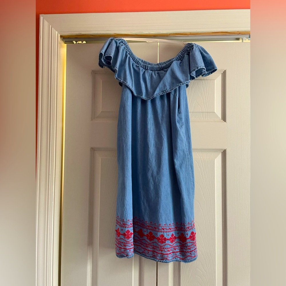 Strapless dress with design bordering around there bottom of the dress